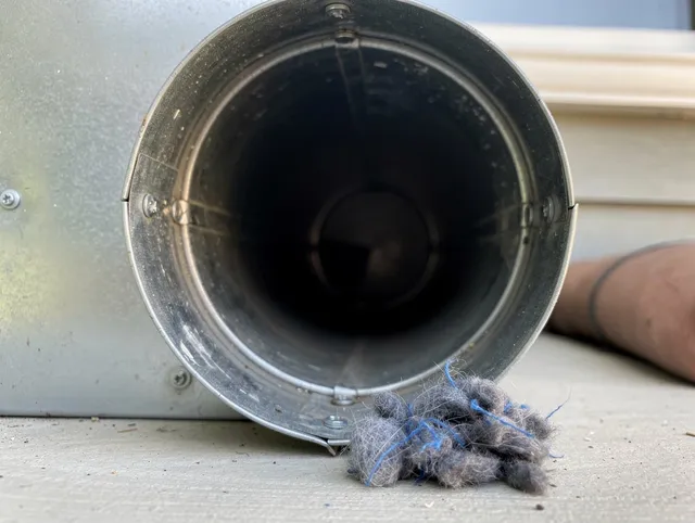 Westport Dryer Vent Cleaning technician using specialized equipment to clear severe dryer vent blockage in Westport